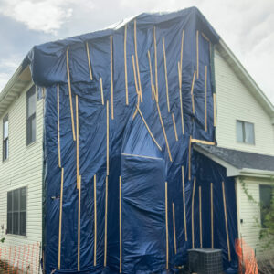 boarded up and tarped house after a house fire