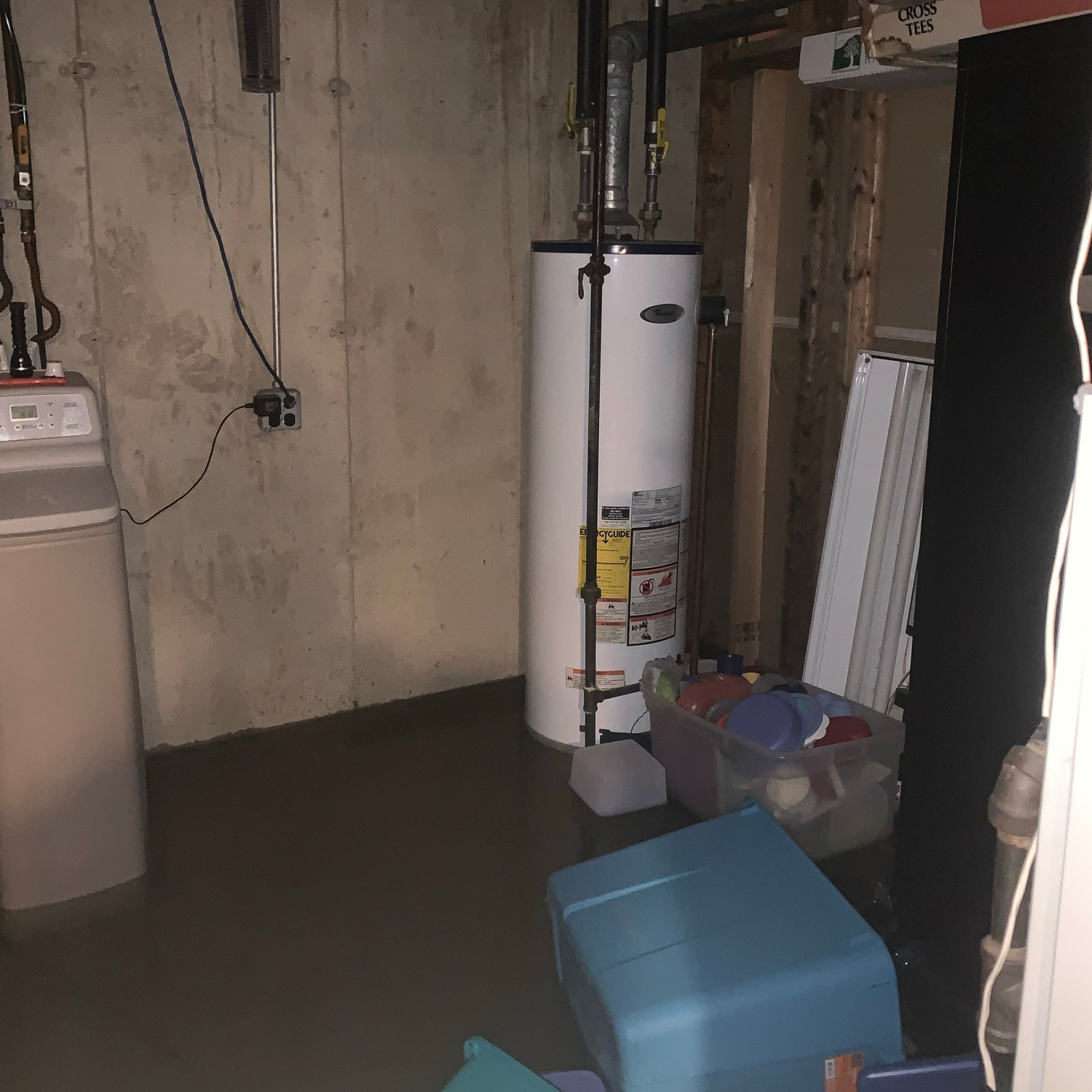 flooded basement. standing water in basement around water heater.