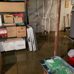 flooded basement before water damage restoration - sump pump failure